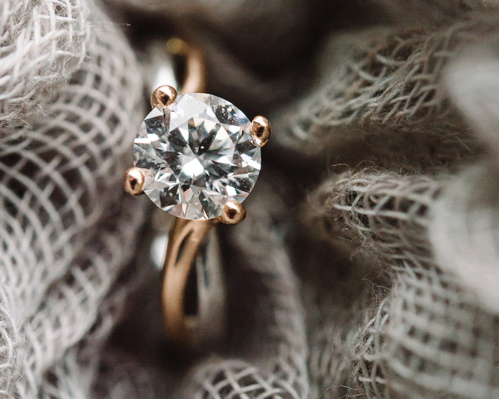 Diamond solitaire ring on natural burlap