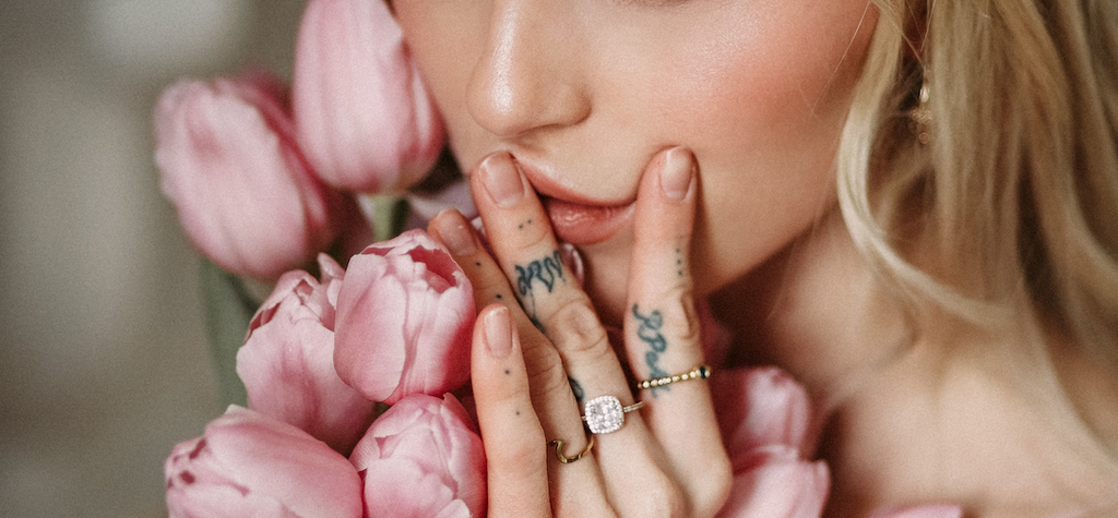 beautiful-woman-holding-pink-roses-with-large-diamond-ring
